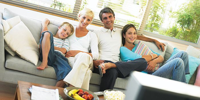 Family watching TV on the couch